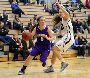Andy Brown / louisburgsportszone@gmail.com Louisburg sophomore guard Madisen Simpson drives to the basket on Feb. 3 against Paola. The Lady Cats fell to No. 2 Paola 51-39. (Top) Louisburg junior Megan Lemke battles for a rebound in Paola.