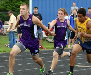 Louisburg senior Mason Wilde (left) takes the handoff from senior teammate Zach Knox during the 4x100-meter relay Friday at the Redbud Relays in Wellsville.