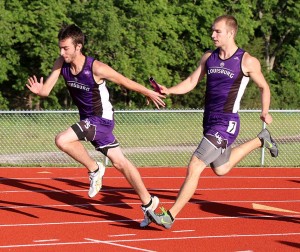 Mason Wilde (right) hands the baton to Kyle Green during the 4x100 relay Thursday. The Wildcat team won the regional title in 44.3 seconds.