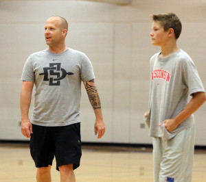 Louisburg boys basketball coach Jason Nelson looks on during the Wildcats' week-long camp Thursday at the high school.