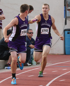 Senior Mason Wilde hands the baton to fellow senior Dawson Christy during the preliminaries of the 4x400-meter relay Friday during the state track meet in Wichita.