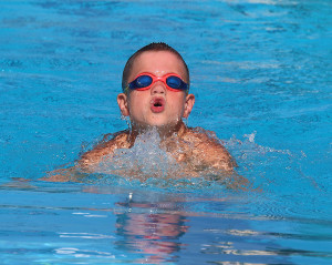 Josiah McCaskill takes a breath in the 25 breaststroke during a home meet earlier this season.
