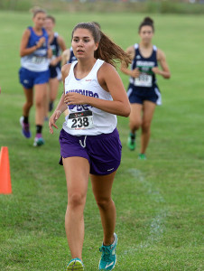 Senior Abby Bergman stays in front of a pack of runners Thursday in Wellsville.