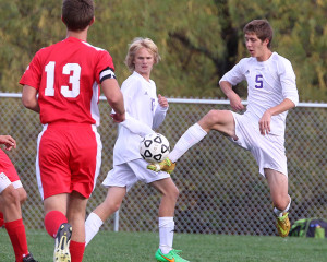 Defender Hunter Mitchell knocks the ball away from a  Fort Scott player Monday in Louisburg.