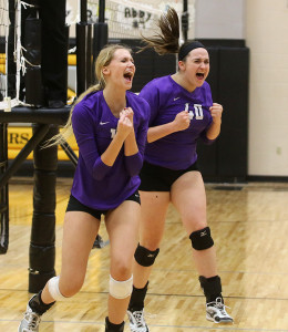 Louisburg's Madison Turner (left) and Olivia Bradley celebrate a big point Tuesday in Paola.