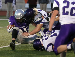 Anders Vance (above) and Grant Harding bring down a Baldwin running back Friday.