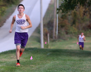Senior Zach Minor runs up the final hill on the course at Lewis-Young Park on Thursday during the Louisburg Invitational. 