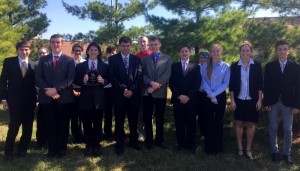 Members of the LHS novice debate team pose with their third-place trophy following last Saturday's competition in Gardner