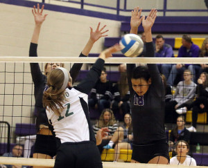Freshman Anna Dixon goes up to block a De Soto kill attempt Saturday during the substate championshp match.