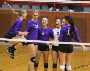 Sophomore Sophie McMullen jumps in the air with excitement as she gathers around teammates (from left) Madison Turner, Megan Lemke, Makenzie Kallevig, Lauren Dunn and Anna Dixon on Friday at the state tournament in Salina