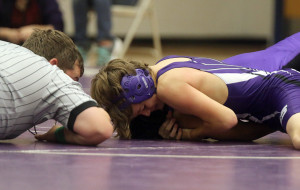 Eighth-grader Dalton Hilt works for a pin during a match earlier this season. Hilt finished the season with a 9-0 record.