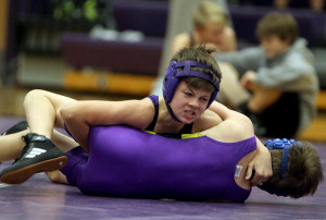 Seventh-grader Ethan Showalter rolls a Spring Hill opponent to his back during a home dual with the Broncos earlier this season. Showalter finished fourth at the league tournament on Nov. 14.