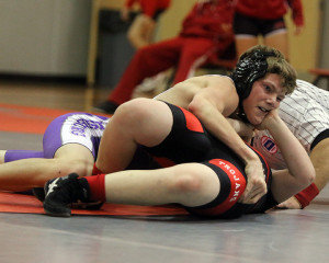 Louisburg's Alec Maler works for a pin during the 138-pound match during Thursday's season opening dual in Osawatomie.