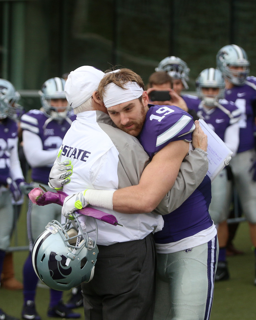 Kody Cook gives K-State coach Bill Snyder a hug before going out onto the field for the final time in Manhattan.
