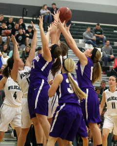 Louisburg's Emalee Overbay (left) and Carson Buffington go up for a rebound Friday in De Soto.