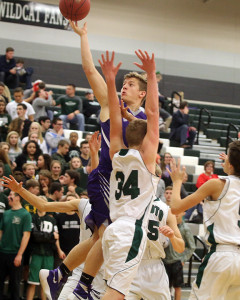 Sophomore Ben Minster lays the ball up for two points during the third quarter of the Wildcats' game Friday in De Soto.