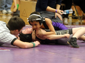 Louisburg's Jacob Meador works for a pin during a match Saturday at the Louisburg Wildcat Classic.
