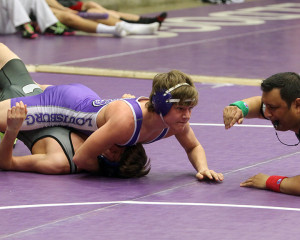 Sophomore Tucker Batten flattens his opponent as he waits for a pin to be called Saturday in Baldwin.