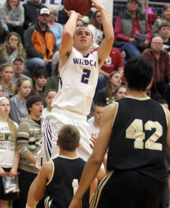 Louisburg junior Sam Guetterman pulls up for a jumper Tuesday during the Wildcats's home game with Paola.