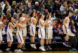 The Louisburg bench leaps into the air with excitement as the buzzer sounds in the Lady Cats' 27-25 win over Eudora. 