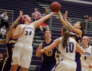 Louisburg junior Emalee Overbay stretches out for a rebound during Friday's home game against Spring Hill. 