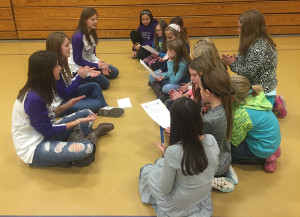 Lady Cat players (from left) Megan Roy, Paige Buffington and Mikayla Quinn teach a group of fourth-graders the LHS fight song on Feb. 2 at Broadmoor Elementary School.