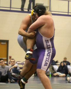 Louisburg senior Anders Vance picks up Spring Hill's Sam Christy by the leg for a takedown Saturday. 