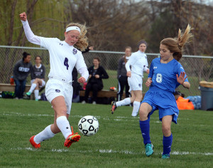 Sophomore Bailey Belcher (left) knocks the ball up the field at home Thursday. Belcher scored one of the three goals in the win.