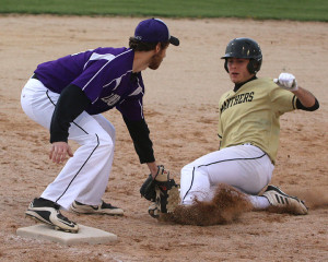 Louisburg third baseman Colton Smith tags out Paola's Mason McDow in the first game of the Wildcats' doubleheader with the Panthers. 