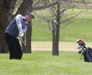 Sophomore Kai Tinich tries to chip onto the green during the Paola Invitational on Monday at Paola Country Club.