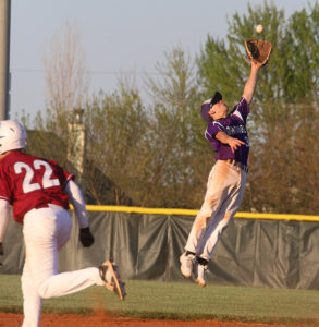 Senior second baseman Cale Schneider leaps into the air to snag a line drive Tuesday in Eudora. 