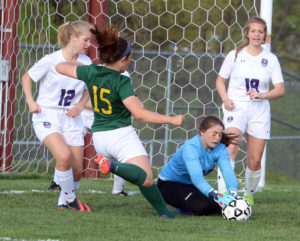 Louisburg goalie Shay Whiting dives to stop a Basehor-Linwood shot Friday in Louisburg. 