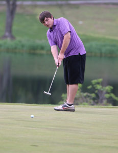 Junior Nick Welch watches as his putt races toward the hold Monday during the Louisburg Invitational. 