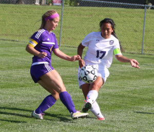 Senior Lilly Scott (right) clears the ball out of the back during Thursday's game in Louisburg.