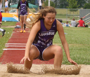 Junior Chloe Renner lands in the sand pit following an attempt in the triple jump Friday in Chanute.