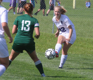 Louisburg junior Bryn O'Meara clears the ball out of the back Tuesday against  De Soto. 