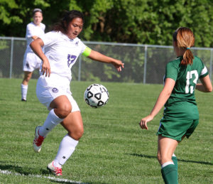 Senior Lilly Scott clears the ball away from a De Soto player on May 24 in Louisburg.