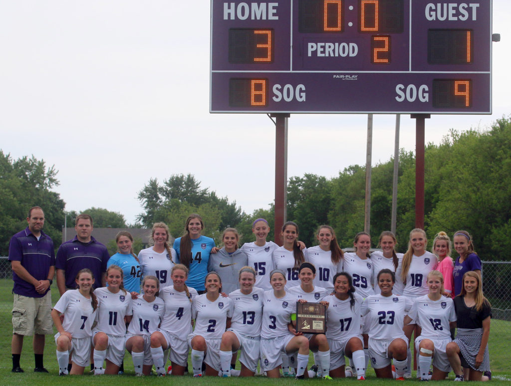 The Louisburg girls soccer team poses with their regional championship trophy Thursday following its 3-1 victory over Basehor-Linwood.