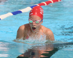 Mable Graham swims to a first-place finish in the breaststroke 