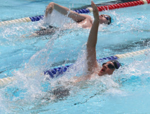 Weston Guetterman swims strong to the finish in the 50-meter backstroke.