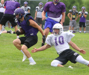 Louisburg running back Thomas San Agustin spins away from a Blue Valley Northwest defender on June 29.