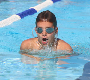 Braden Branine swims to the finish in the breaststroke against Woodson.