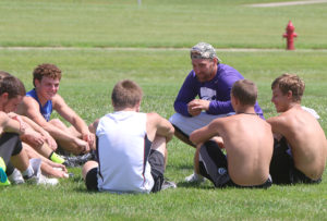 LHS grad Kody Cook talks to a group of current Wildcat football players and gives them some advice on their upcoming season.