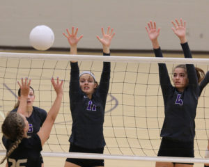 Junior Mikayla Quinn (left) and freshman Haley Cain go up for a block during the Lady Cats' semifinal match against Paola.