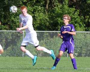 Scott Murphy heads the ball away from teammate Chris Williams Friday during the team's annual scrimmage.