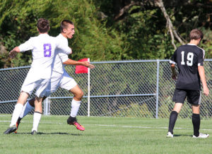 Herman Knipp celebrates with teammate Calvin Cassida (8) after scoring Louisburg's first goal Tuesday against Paola.