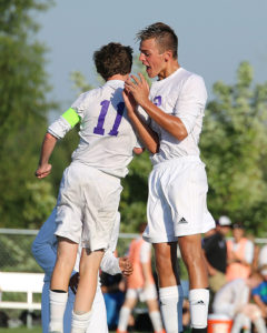 Kris Light (right) celebrates with teammate Grant Ryals  following Ryals' goal Thursday in the win over Bonner Springs.