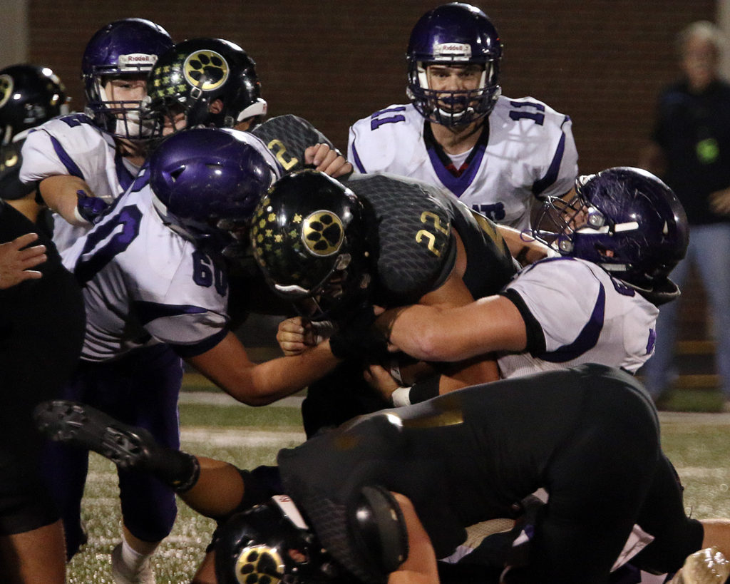 Seniors Dustyn Rizzo (left) and Mason Koechner team up for a tackle.