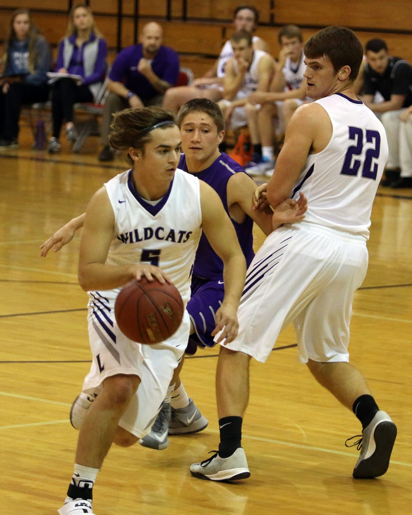 Louisburg senior Jake Hill dribbles toward the basket during Tuesday's  contest in Baldwin.