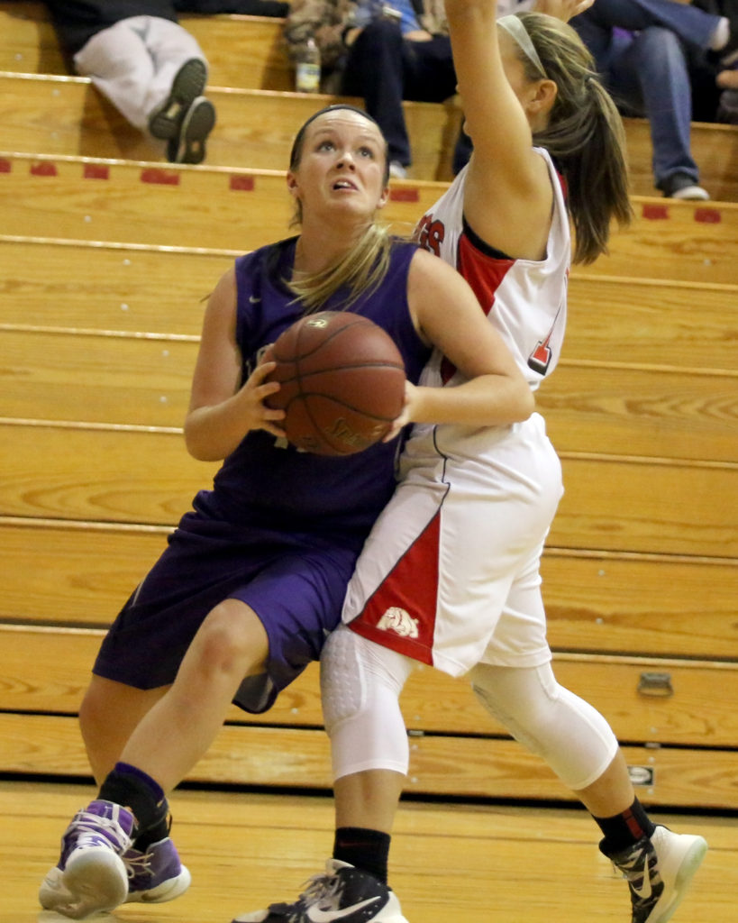 Senior Madisen Simpson draws a foul as she goes up for a shot during Friday's contest against Anderson County.